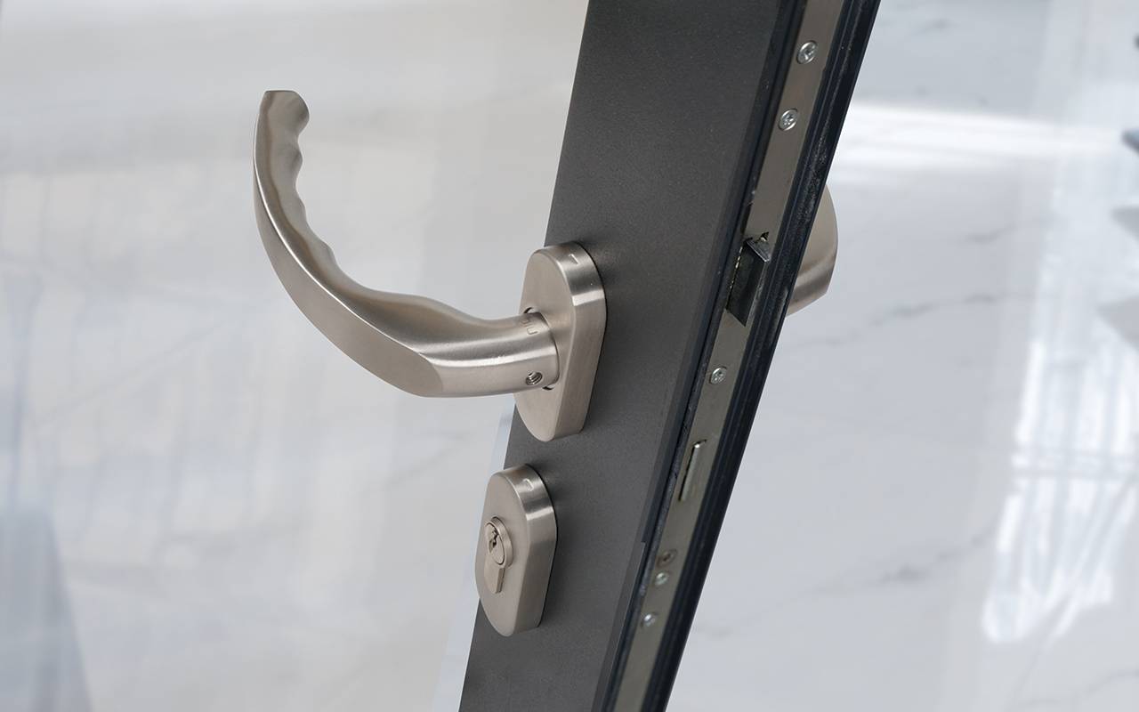 Stainless Steel Ergonomic Lever Door Handle on Oval Rose - BLU™  KM930 | Coastal Group 