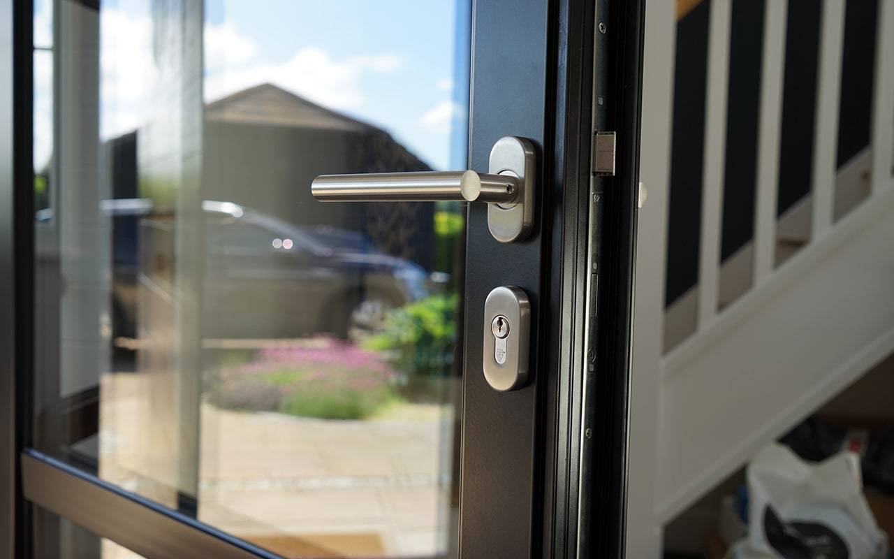 Stainless Steel TBar Lever Door Handle On Oval Rose BLU™ KM965