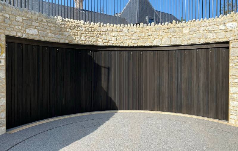 Concave sliding door creates unique curved garage space in redevelopment project