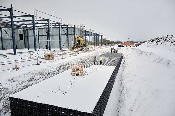 A construction site with snow AI-generated content may be incorrect.