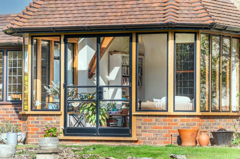 Sensitive window and door replacement looks sensational filling this Arts and Craft home with natural light