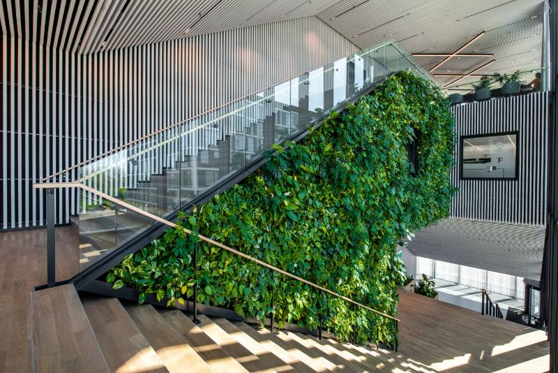 Modern meeting place with vertical greenery adapts design to sustainable construction