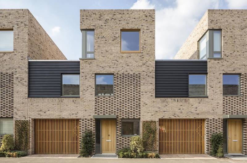 Ventilated garage doors enable seamless integration of vertical timber cladding