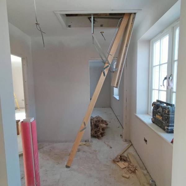 Timber loft ladder provides access to solar inverters in new-build housing development