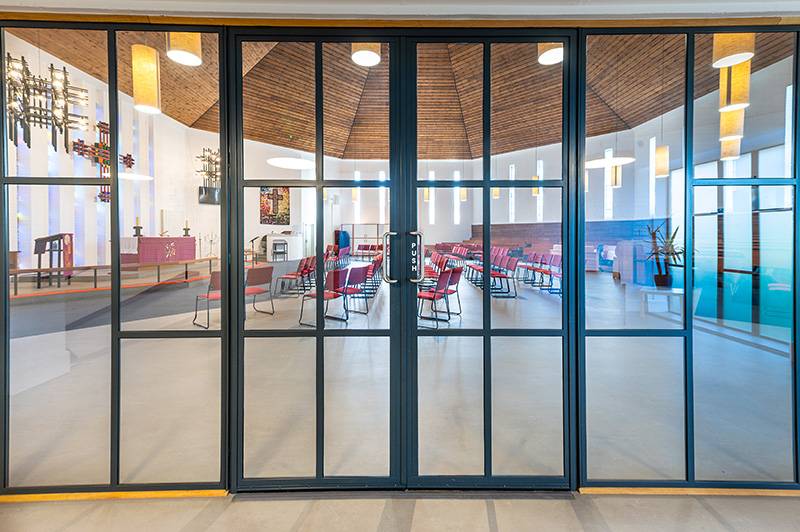 Striking steel door screen and matching window for Church renovation