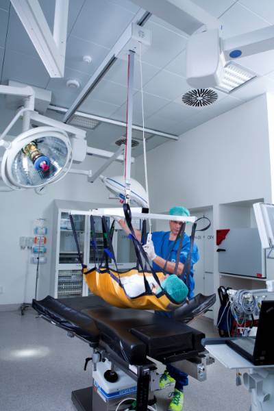 Ceiling-mounted hoists in operating theatres facilitate work