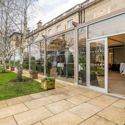 Timber Pergola Awning with Retractable Roof and Folding Glass Doors