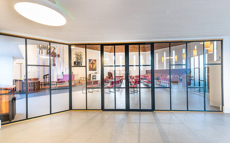 Striking metal door screen and matching window for Church renovation