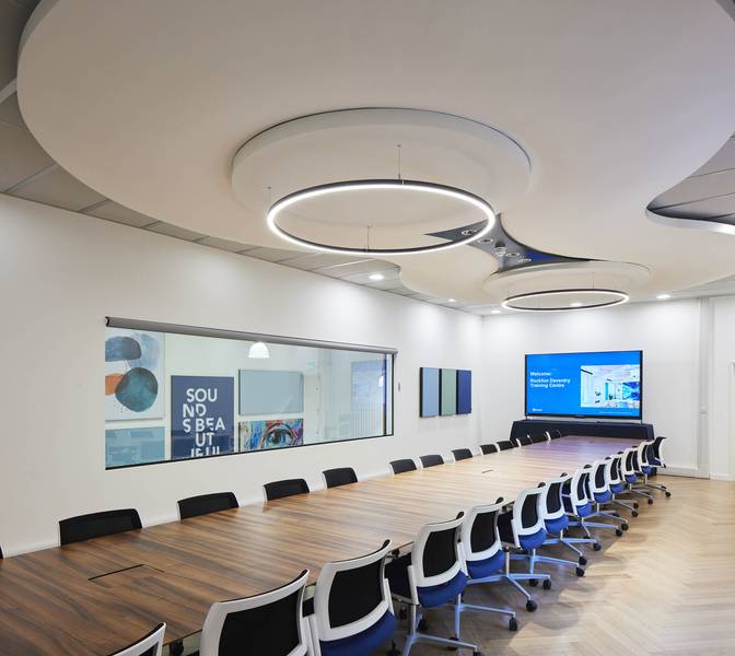 Unique, seamless Mono Acoustic ceiling feature floats perfectly above a board room meeting table