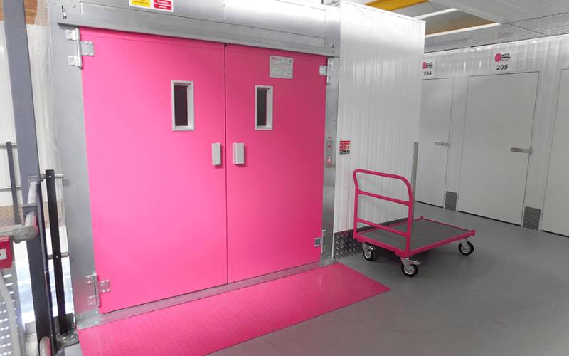 Customised goods lift matching corporate colour of Pink Hippo Self-Storage