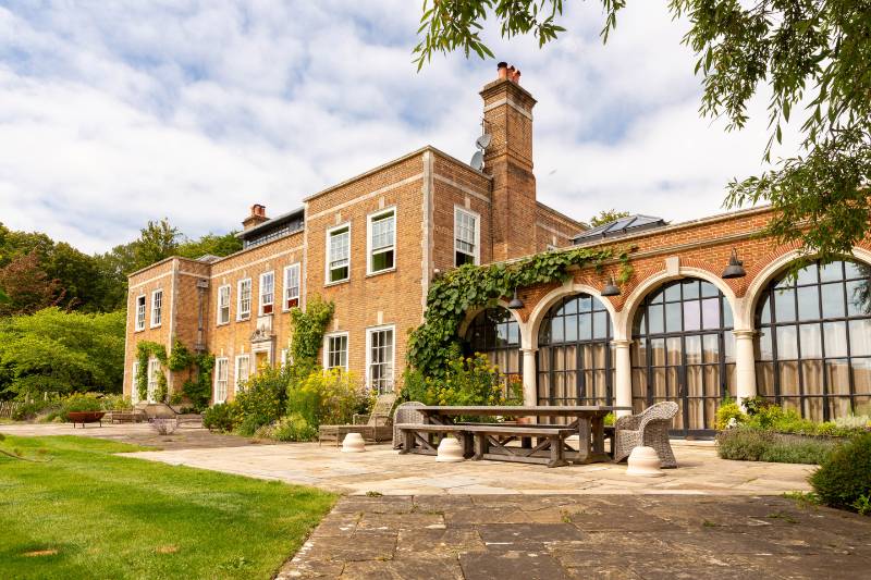 Arched head steel doors make a spectacular feature at this 20th Century Country House.