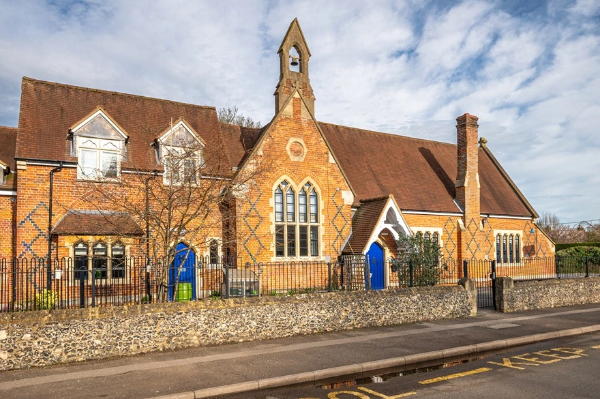 A combination of intricately shaped head windows manufactured by Clement for historic school